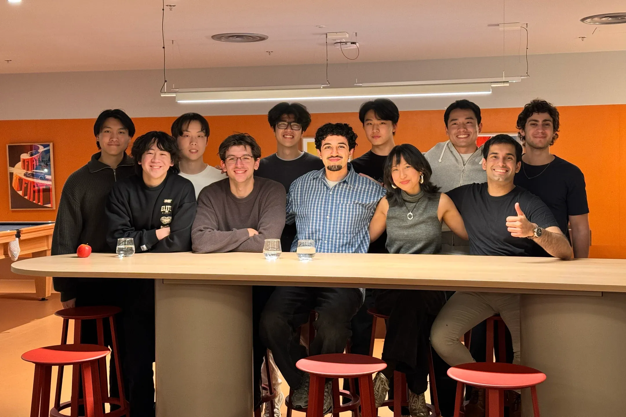 Jeffrey Lin with a group of colleagues behind a counter in an Affinda breakout space.